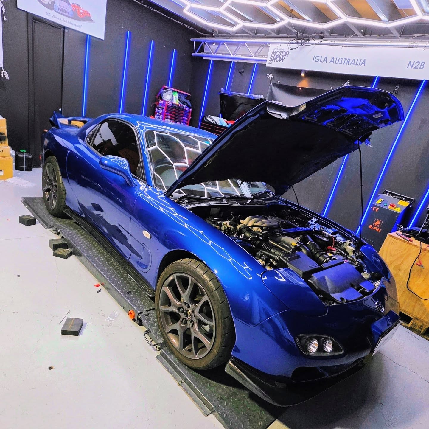 Blue Mazda RX-7 with bonnet up at Euro Chiptuning Solutions